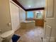Bathroom featuring tile floor, vanity, toilet, and a luxurious soaking tub at 5570 George Henry Dr, Hickory, NC 28602