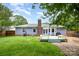 Backyard featuring a patio, lawn, mature trees, and privacy fence at 5711 Lambrook Ct, Charlotte, NC 28269