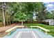 Spacious backyard featuring a wooden deck and a lush green lawn with lots of trees at 5711 Lambrook Ct, Charlotte, NC 28269