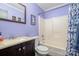 Bathroom features a vanity, toilet, bathtub with shower and a framed mirror at 5711 Lambrook Ct, Charlotte, NC 28269