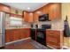 Kitchen featuring stainless steel appliances, granite counters and dark wood cabinets at 5711 Lambrook Ct, Charlotte, NC 28269