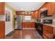 Kitchen featuring stainless steel appliances, granite counters and dark wood cabinets at 5711 Lambrook Ct, Charlotte, NC 28269