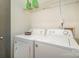 Functional laundry area with washer, dryer, and overhead storage shelf at 5711 Lambrook Ct, Charlotte, NC 28269