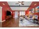 Cozy living room with vaulted ceilings, ceiling fan, wood floors, and a comfortable seating area at 5711 Lambrook Ct, Charlotte, NC 28269
