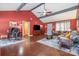 Inviting living room with vaulted ceilings, ceiling fan, wood floors, and a cozy seating area at 5711 Lambrook Ct, Charlotte, NC 28269