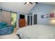Main bedroom featuring a private bath with a slider door entry and natural light at 5711 Lambrook Ct, Charlotte, NC 28269