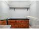 Well-organized walk-in closet features shelving, a wooden clothes bar, and a dresser at 5711 Lambrook Ct, Charlotte, NC 28269