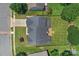 Aerial view showcasing the home's roof, deck, and surrounding manicured lawn at 7800 Conifer Cir, Indian Trail, NC 28079