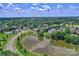 Beautiful aerial view of a neighborhood surrounding a serene pond and lush greenery at 7800 Conifer Cir, Indian Trail, NC 28079