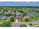 Aerial shot of the home in a neighborhood with a lake and mature trees at 7800 Conifer Cir, Indian Trail, NC 28079