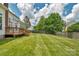 Spacious backyard featuring a wooden deck and a freshly cut lawn at 7800 Conifer Cir, Indian Trail, NC 28079