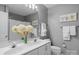 Well-lit bathroom featuring a double vanity, framed mirror, and coordinated towel racks at 7800 Conifer Cir, Indian Trail, NC 28079