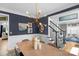 Elegant dining room with a statement lighting fixture, navy blue accent wall, and sophisticated decor at 7800 Conifer Cir, Indian Trail, NC 28079