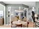 Dining area with views to multiple sitting areas has a modern light fixture and lots of natural light at 7800 Conifer Cir, Indian Trail, NC 28079