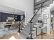 Bright foyer featuring a staircase with decorative black wrought iron railings and adjacent dining area at 7800 Conifer Cir, Indian Trail, NC 28079