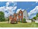 Stately brick home with manicured lawn, black shutters and mature landscaping at 7800 Conifer Cir, Indian Trail, NC 28079
