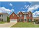 Charming two-story brick home with a well-manicured lawn and beautiful landscaping under a cloudy sky at 7800 Conifer Cir, Indian Trail, NC 28079