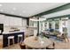 Eat-in kitchen with breakfast bar boasts stainless appliances, white cabinets and adjacent sitting room at 7800 Conifer Cir, Indian Trail, NC 28079