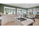 This kitchen features an island cooktop, white countertops and cabinets, and views to the sitting room at 7800 Conifer Cir, Indian Trail, NC 28079