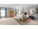 Spacious main bedroom with a four-poster bed, tray ceiling, and natural light from windows at 7800 Conifer Cir, Indian Trail, NC 28079