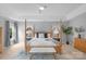 Spacious main bedroom with a four-poster bed, tray ceiling, and natural light from windows at 7800 Conifer Cir, Indian Trail, NC 28079