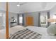 Main bedroom featuring a four-poster bed, light-gray walls, and tray ceiling with recessed lighting at 7800 Conifer Cir, Indian Trail, NC 28079