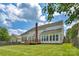 Rear of the home with a patio, large windows, and a well-kept lawn at 7800 Conifer Cir, Indian Trail, NC 28079