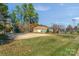 Community volleyball court surrounded by mature trees and a nearby pool house at 7800 Conifer Cir, Indian Trail, NC 28079