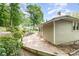 Exterior view of a home with a brick patio and lush greenery at 816 Fulton St, Albemarle, NC 28001