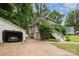 View of a charming home with a detached garage and lovely landscaping at 816 Fulton St, Albemarle, NC 28001