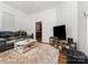 Comfortable living room with neutral walls, decorative rug, and modern entertainment center at 816 Fulton St, Albemarle, NC 28001