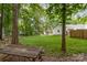 Spacious backyard with mature trees, a picnic table, and a gazebo at 827 Ashwyn Dr, Charlotte, NC 28211