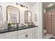 Stylish bathroom featuring dual glass vessel sinks, shiplap walls, and a shower with a curtain at 827 Ashwyn Dr, Charlotte, NC 28211
