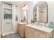 Modern bathroom featuring double vanities, arched mirrors, and a tiled shower at 827 Ashwyn Dr, Charlotte, NC 28211