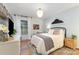 Cozy bedroom showcasing stylish decor, hardwood floors, window and chandelier at 827 Ashwyn Dr, Charlotte, NC 28211