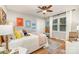 Bright bedroom with stylish decor, featuring hardwood floors, window and ceiling fan at 827 Ashwyn Dr, Charlotte, NC 28211