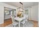 Elegant dining room featuring a modern light fixture, wainscoting, and a view into the living room at 827 Ashwyn Dr, Charlotte, NC 28211
