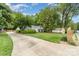 Wide driveway leading to a charming home with a lush front yard at 827 Ashwyn Dr, Charlotte, NC 28211