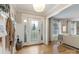 Bright entryway with hardwood floors, a decorative front door, and a view into the cozy living room at 827 Ashwyn Dr, Charlotte, NC 28211