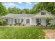 Charming single-story home featuring a welcoming front porch, well-maintained lawn, and manicured landscaping at 827 Ashwyn Dr, Charlotte, NC 28211