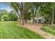 Well-manicured front yard with mature trees and tasteful landscaping at 827 Ashwyn Dr, Charlotte, NC 28211