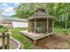 Outdoor gazebo with wooden deck and screened walls, surrounded by trees at 827 Ashwyn Dr, Charlotte, NC 28211
