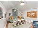 Cozy living room with comfortable seating, bookshelf and white-paneled walls at 827 Ashwyn Dr, Charlotte, NC 28211