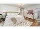 Serene main bedroom with white walls, a decorative rug, and ample natural light at 827 Ashwyn Dr, Charlotte, NC 28211
