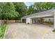 Large parking area with garage, carport, and fenced in area at 827 Ashwyn Dr, Charlotte, NC 28211