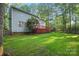 The backyard has a well-maintained lawn and a deck, bordered by a wooden fence and mature trees at 8805 Deerland Ct, Huntersville, NC 28078