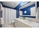 This bathroom features a double sink vanity, a large mirror, and a shower with a curtain at 8805 Deerland Ct, Huntersville, NC 28078