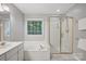 Bathroom features a large tub, a separate shower, a window and neutral paint at 8805 Deerland Ct, Huntersville, NC 28078