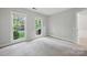 Bright bedroom with neutral walls, plush carpeting, and two windows for natural light at 8805 Deerland Ct, Huntersville, NC 28078