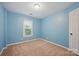 Bedroom with blue painted walls, a carpeted floor, a window and white trim at 8805 Deerland Ct, Huntersville, NC 28078